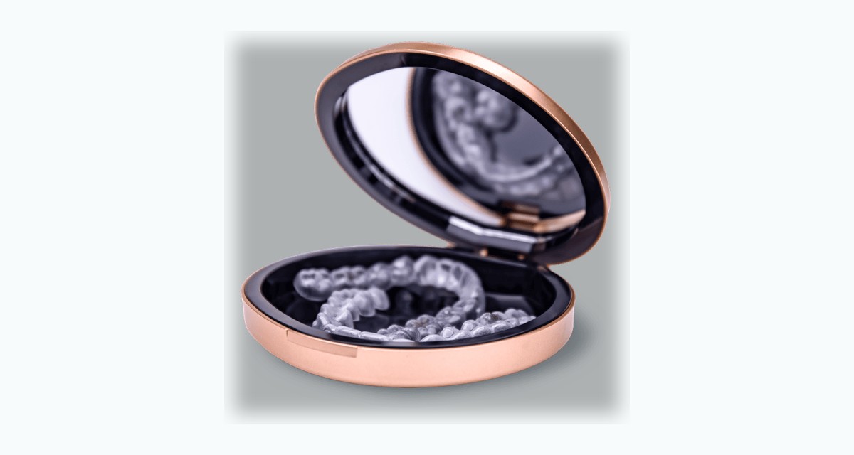 Angel Aligner clear trays inside a rose gold round aligner case